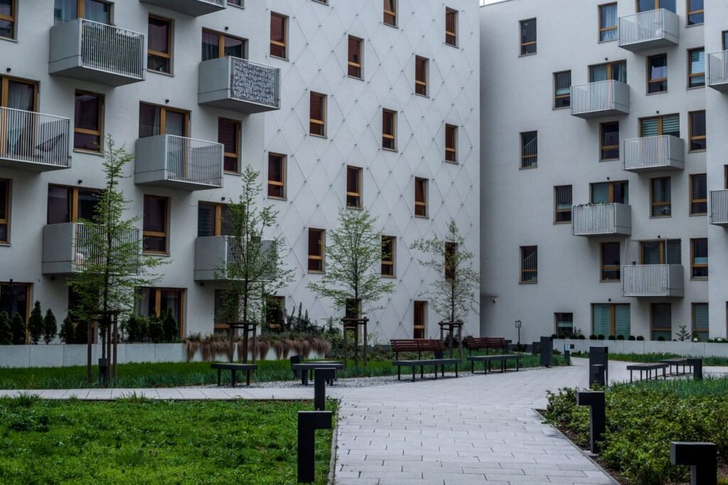 Contemporary apartment complex with landscaped courtyard and balconies.